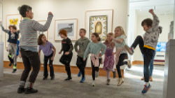Kids jumping with a docent in the museum's Inuit gallery.